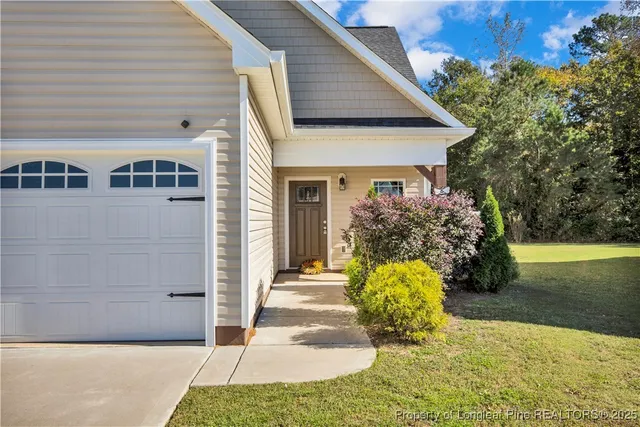 a front view of a house with garden