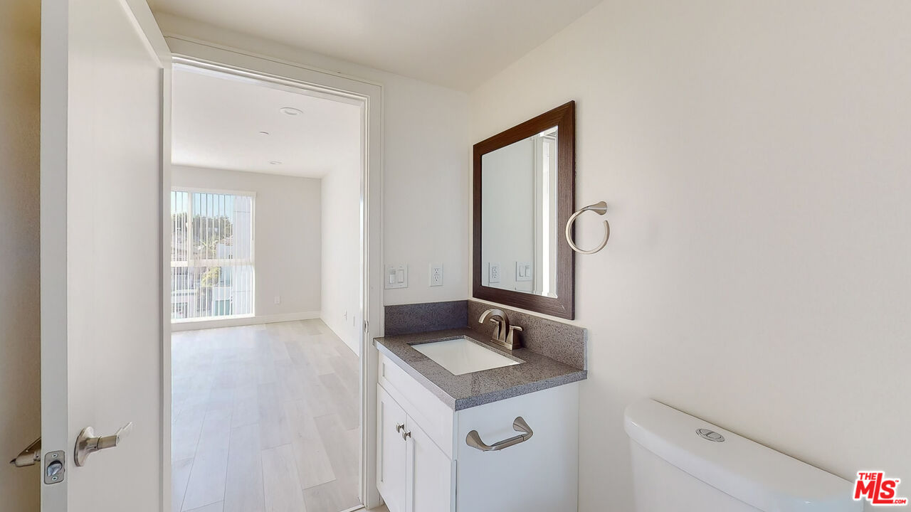 252 Rosemont Avenue, Unit 1/2 Los Angeles, CA 90026 - Photo 11 of 30 a bathroom with a sink vanity and a mirror