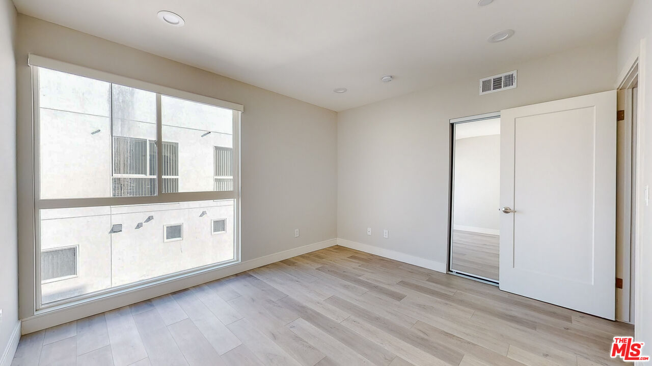 252 Rosemont Avenue, Unit 1/2 Los Angeles, CA 90026 - Photo 12 of 30 a view of utility room with window and wooden floor