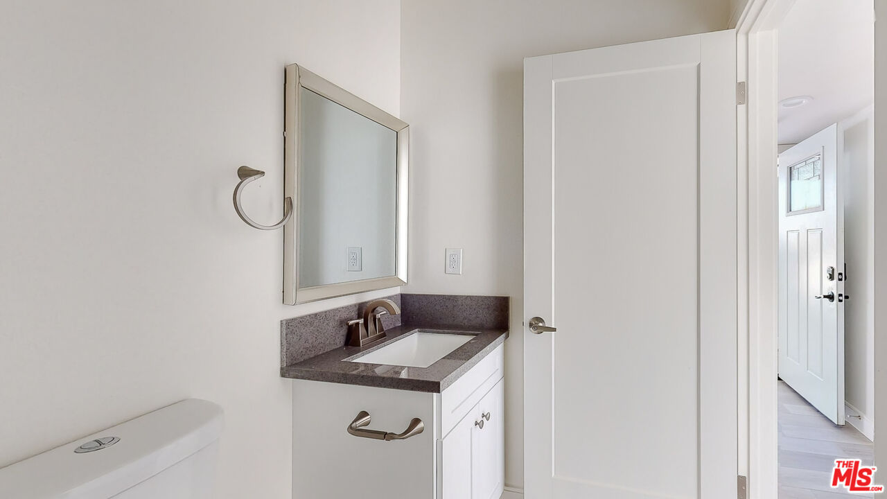 252 Rosemont Avenue, Unit 1/2 Los Angeles, CA 90026 - Photo 17 of 30 a bathroom with a sink and a mirror