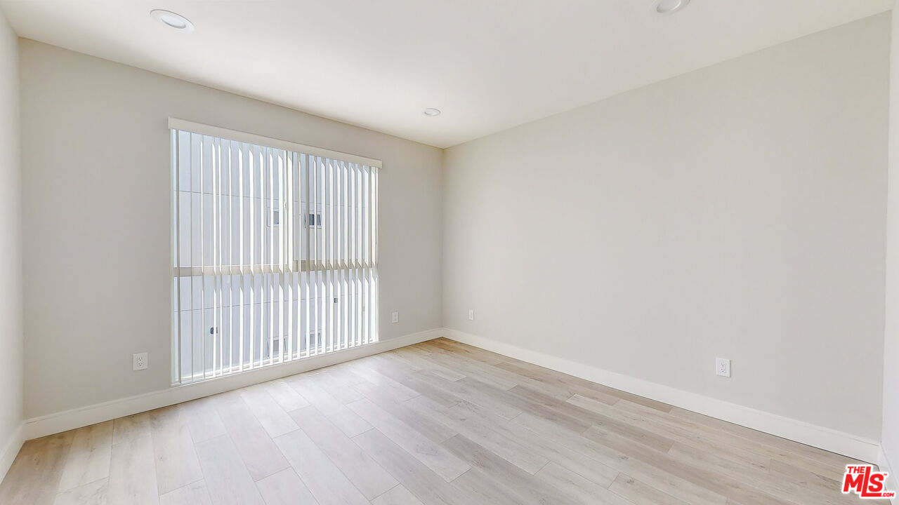252 Rosemont Avenue, Unit 1/2 Los Angeles, CA 90026 - Photo 22 of 30 an empty room with wooden floor and windows