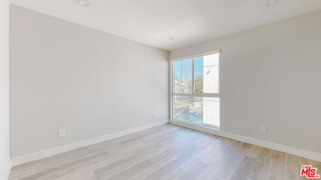 252 Rosemont Avenue, Unit 1/2 Los Angeles, CA 90026 - Photo 23 of 30 an empty room with wooden floor and window