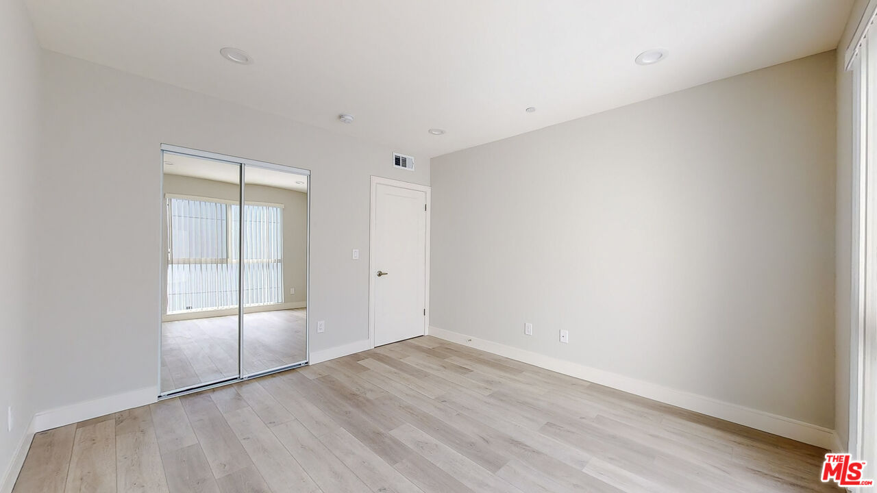 252 Rosemont Avenue, Unit 1/2 Los Angeles, CA 90026 - Photo 24 of 30 an empty room with wooden floor and windows
