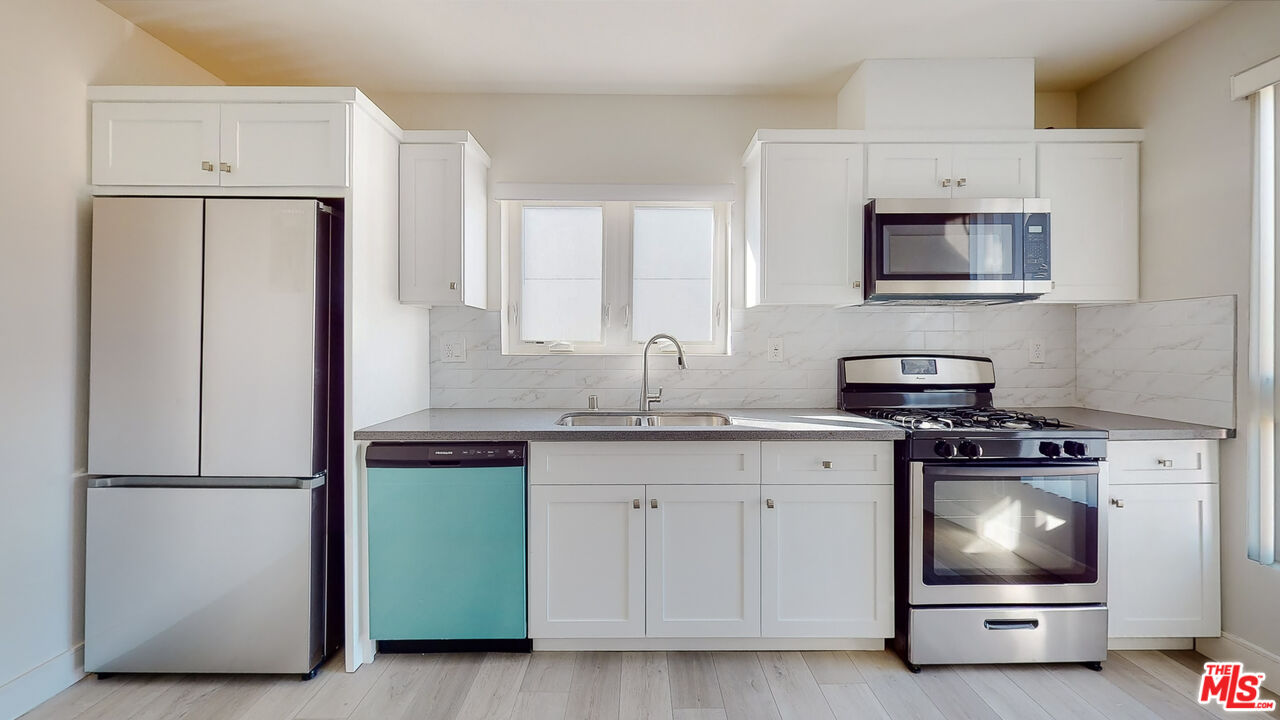 252 Rosemont Avenue, Unit 1/2 Los Angeles, CA 90026 - Photo 3 of 30 a kitchen with a sink and a refrigerator