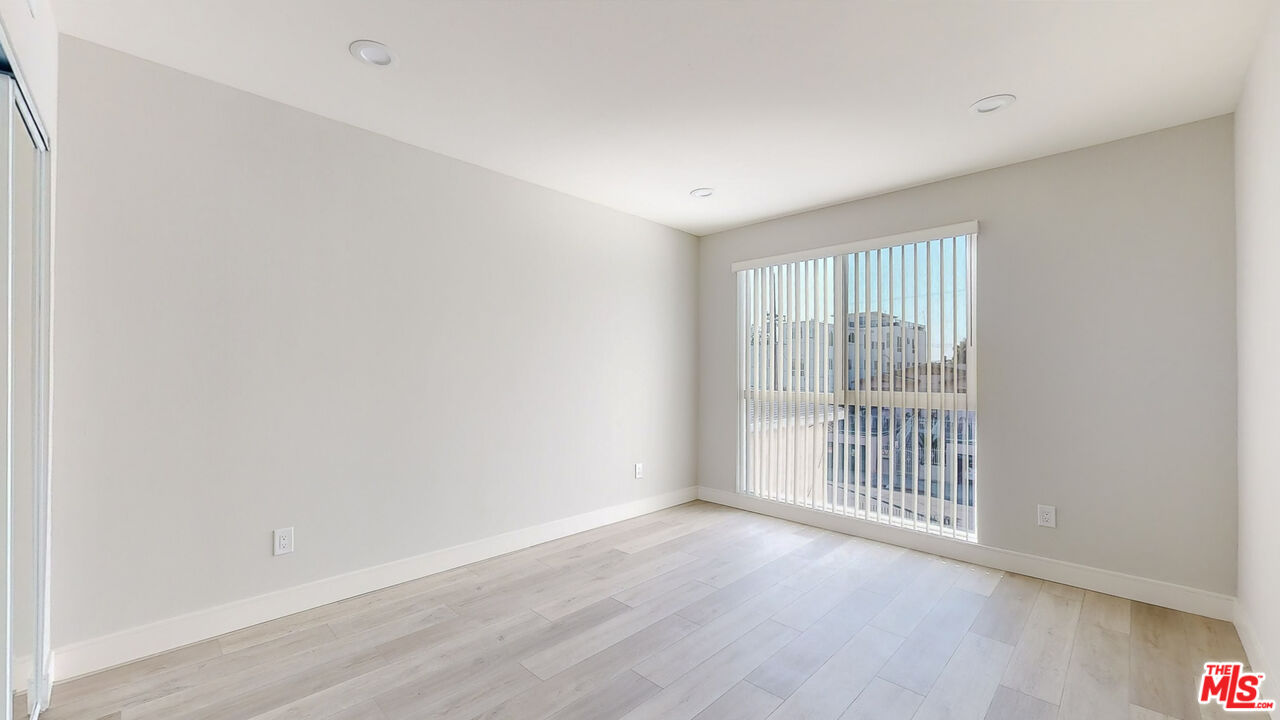 252 Rosemont Avenue, Unit 1/2 Los Angeles, CA 90026 - Photo 5 of 30 an empty room with wooden floor and windows