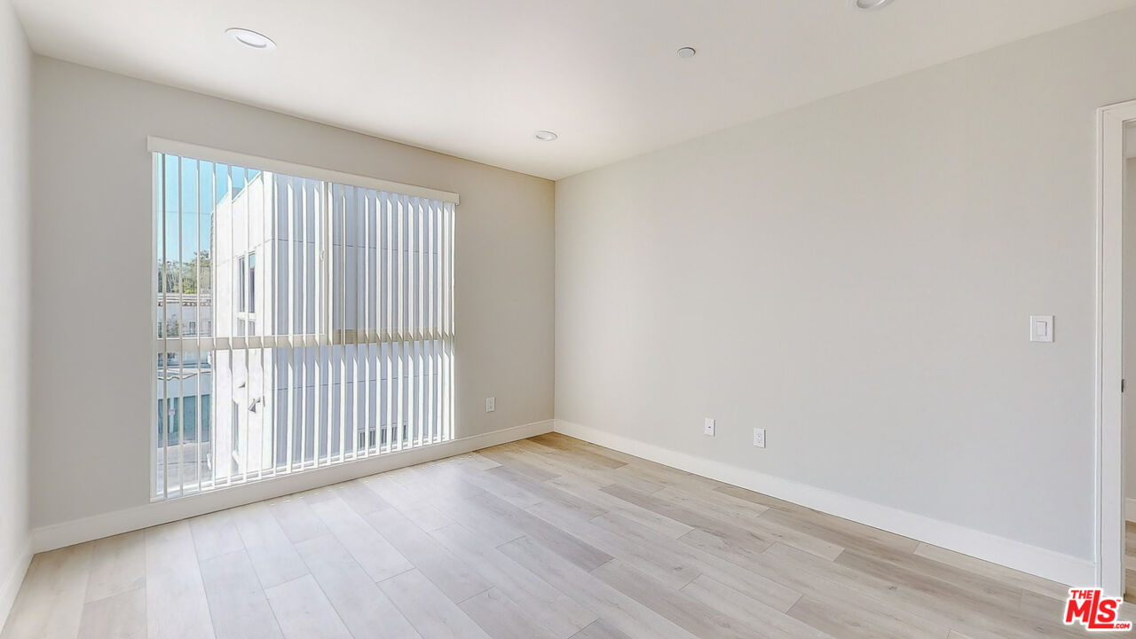 252 Rosemont Avenue, Unit 1/2 Los Angeles, CA 90026 - Photo 6 of 30 a view of a livingroom with wooden floor and fence