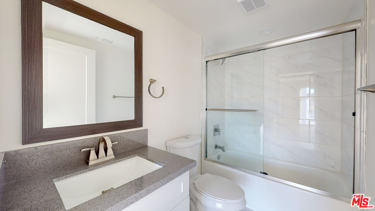 252 Rosemont Avenue, Unit 1/2 Los Angeles, CA 90026 - Photo 8 of 30 a bathroom with a granite countertop sink toilet and shower