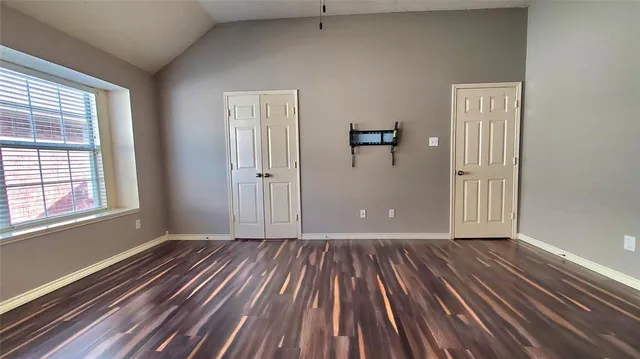 a view of a room with wooden floor and window