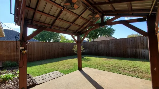 a view of a backyard with a tree
