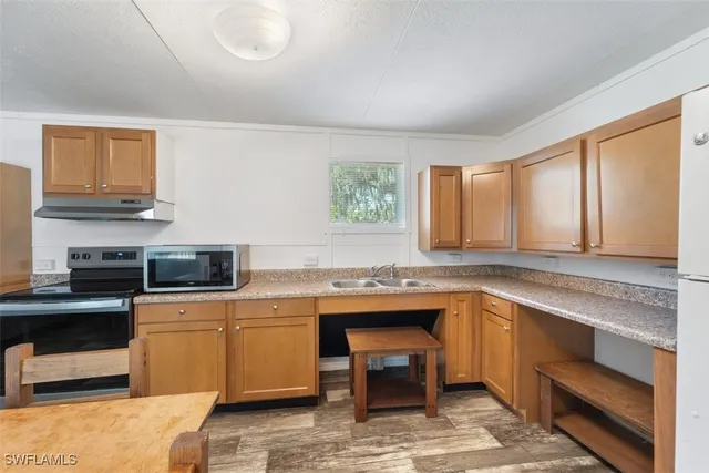 a kitchen with a sink stove and microwave