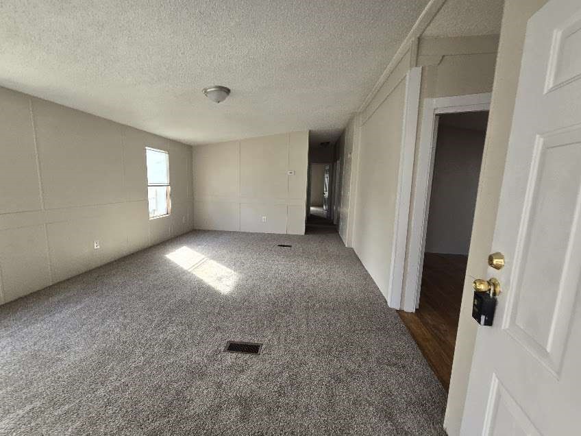 5815 Dylan Drive Baytown, TX 77521 - Photo 2 of 7 an empty room with windows