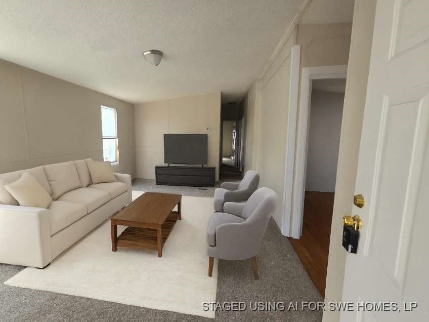 5815 Dylan Drive Baytown, TX 77521 - Photo 3 of 7 a living room with furniture and a flat screen tv