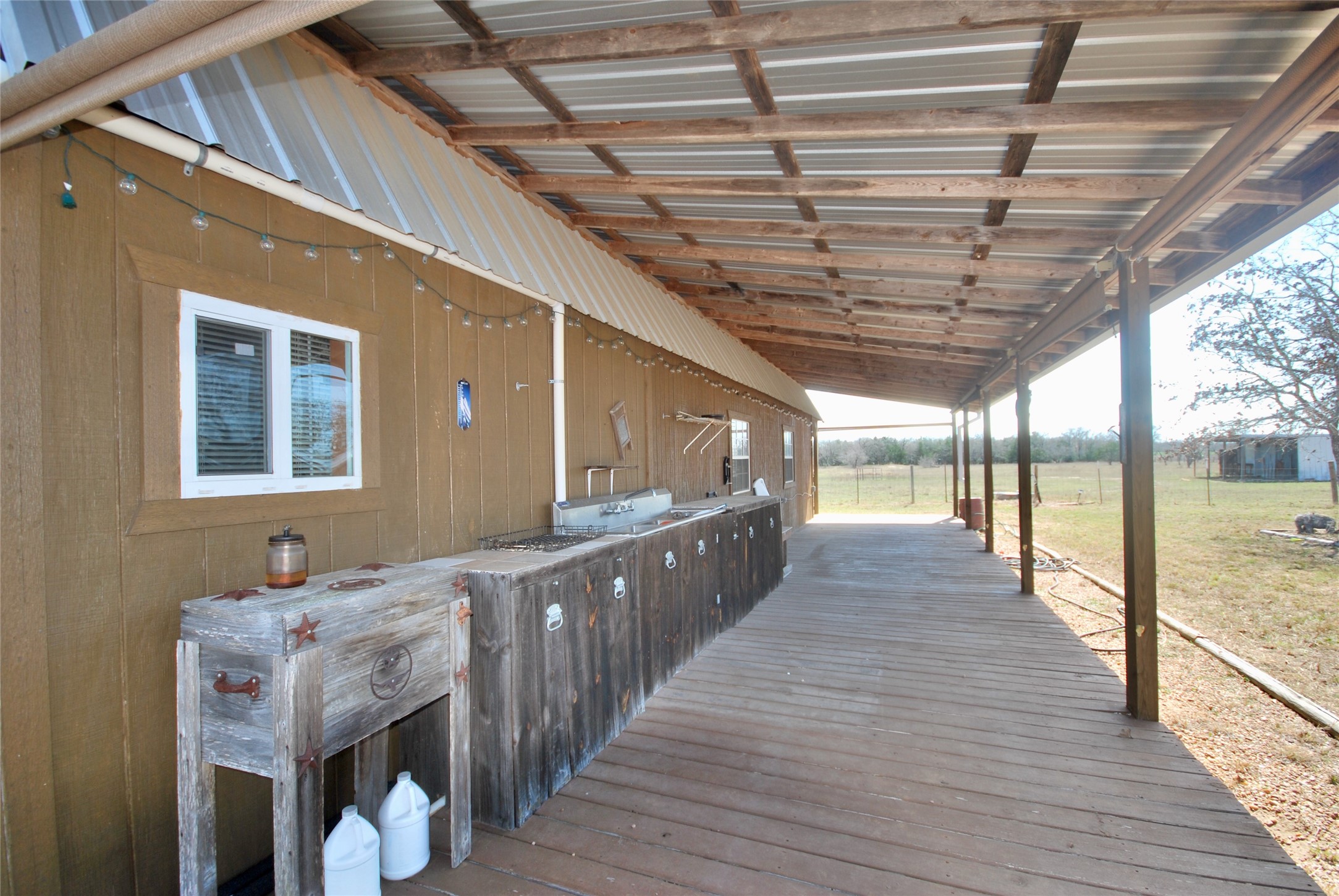4850 Burke Road Flatonia, TX 78941 - Photo 13 of 45 a view of a porch with wooden floor and iron stairs