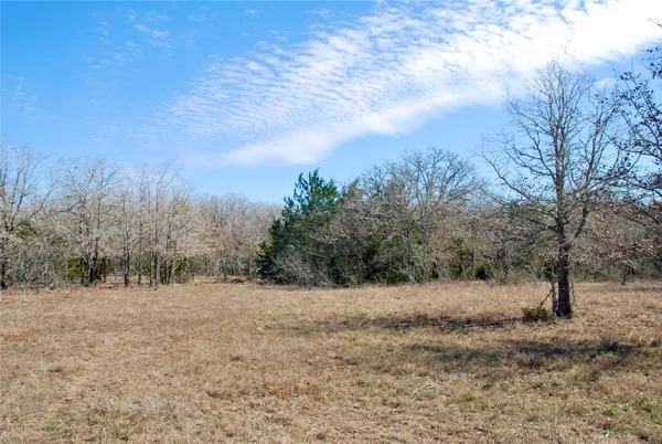an aerial view of a house with a yard and covered with snow