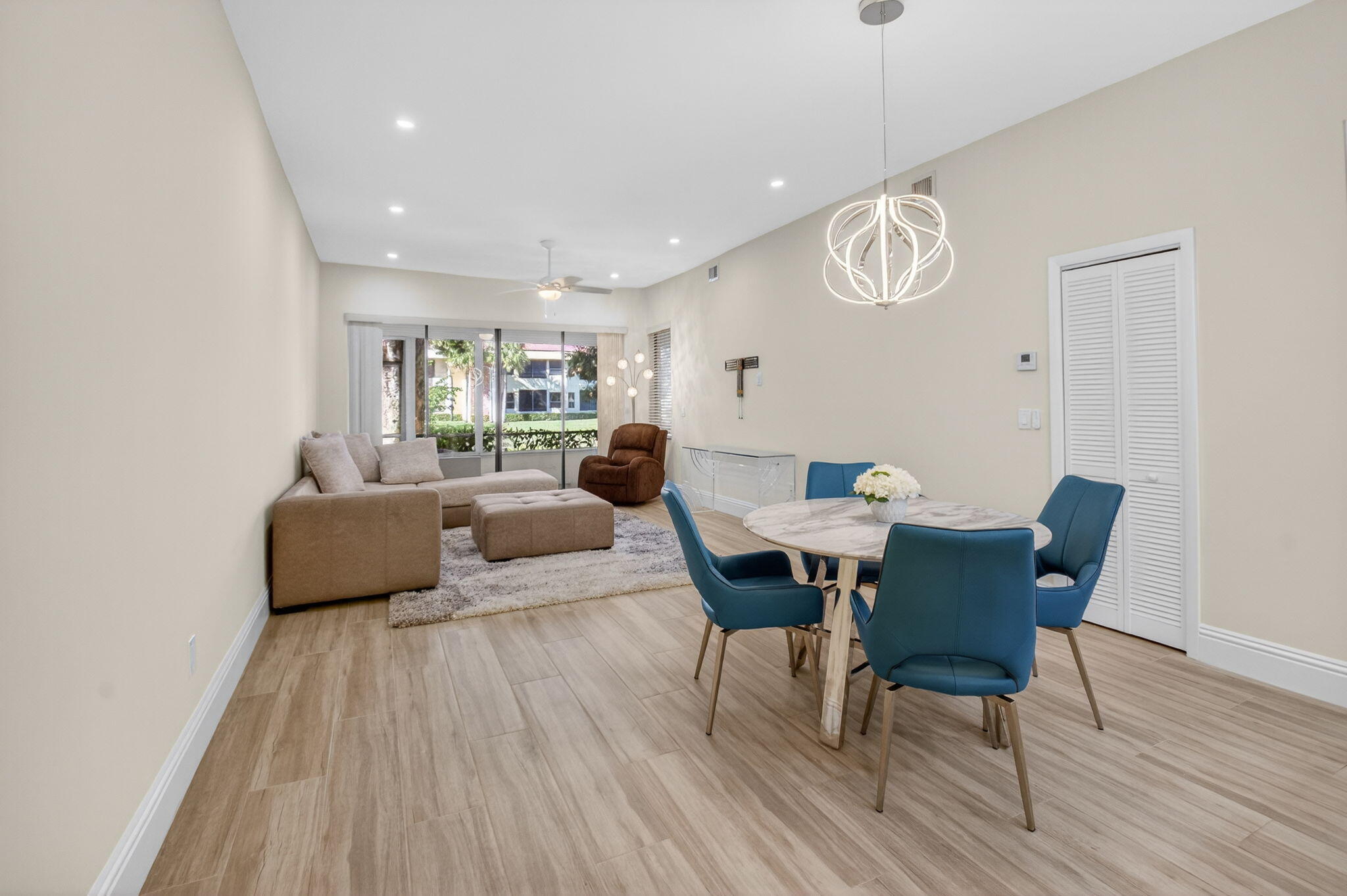 7484 La Paz Boulevard, Unit 103 Boca Raton, FL 33433 - Photo 12 of 50 a living room with furniture and wooden floor