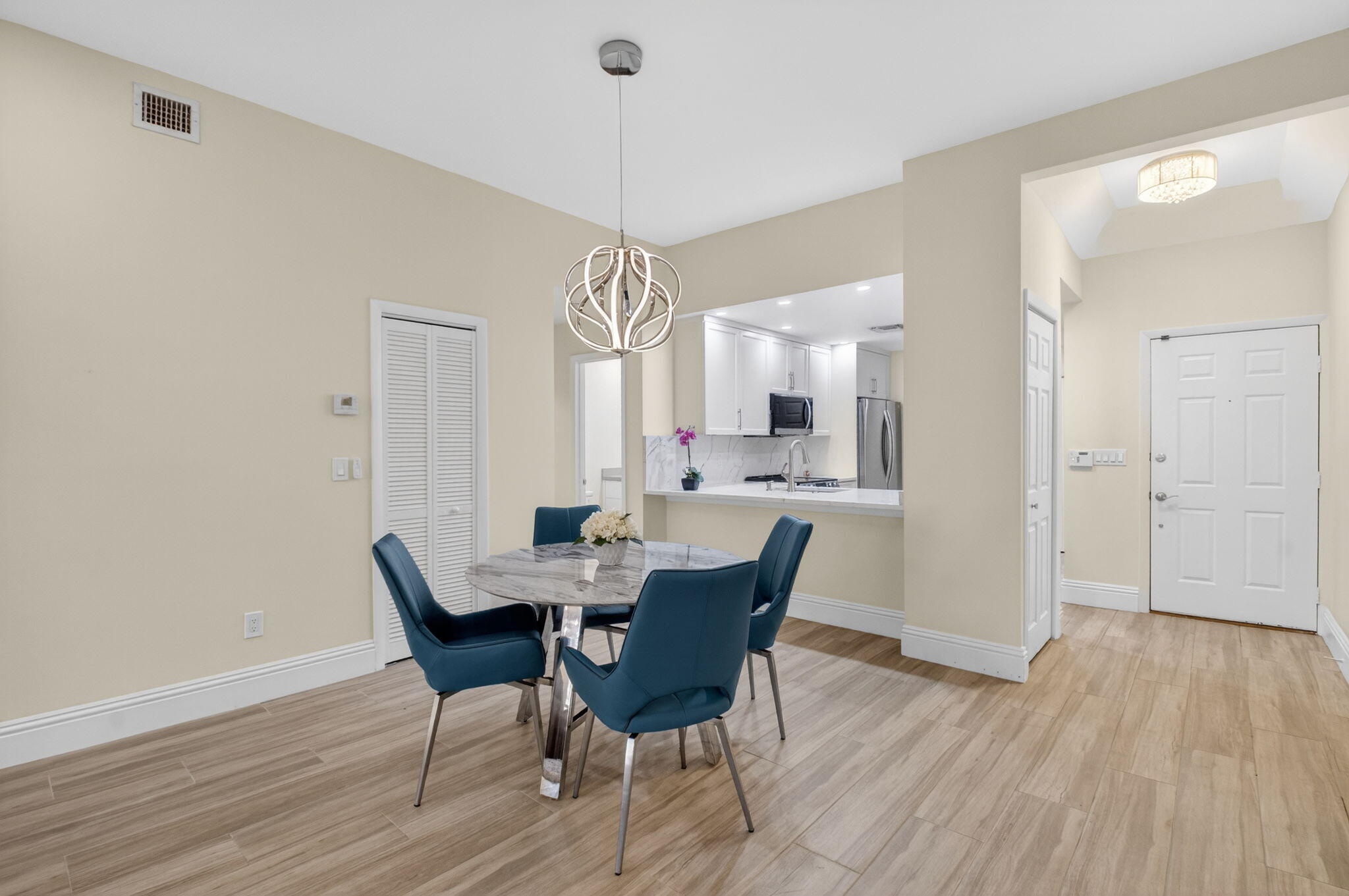 7484 La Paz Boulevard, Unit 103 Boca Raton, FL 33433 - Photo 14 of 50 a view of a dining room with furniture and wooden floor