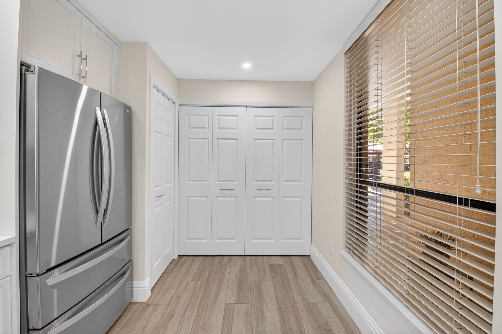 7484 La Paz Boulevard, Unit 103 Boca Raton, FL 33433 - Photo 19 of 50 a view of a hallway with closet and wooden floor