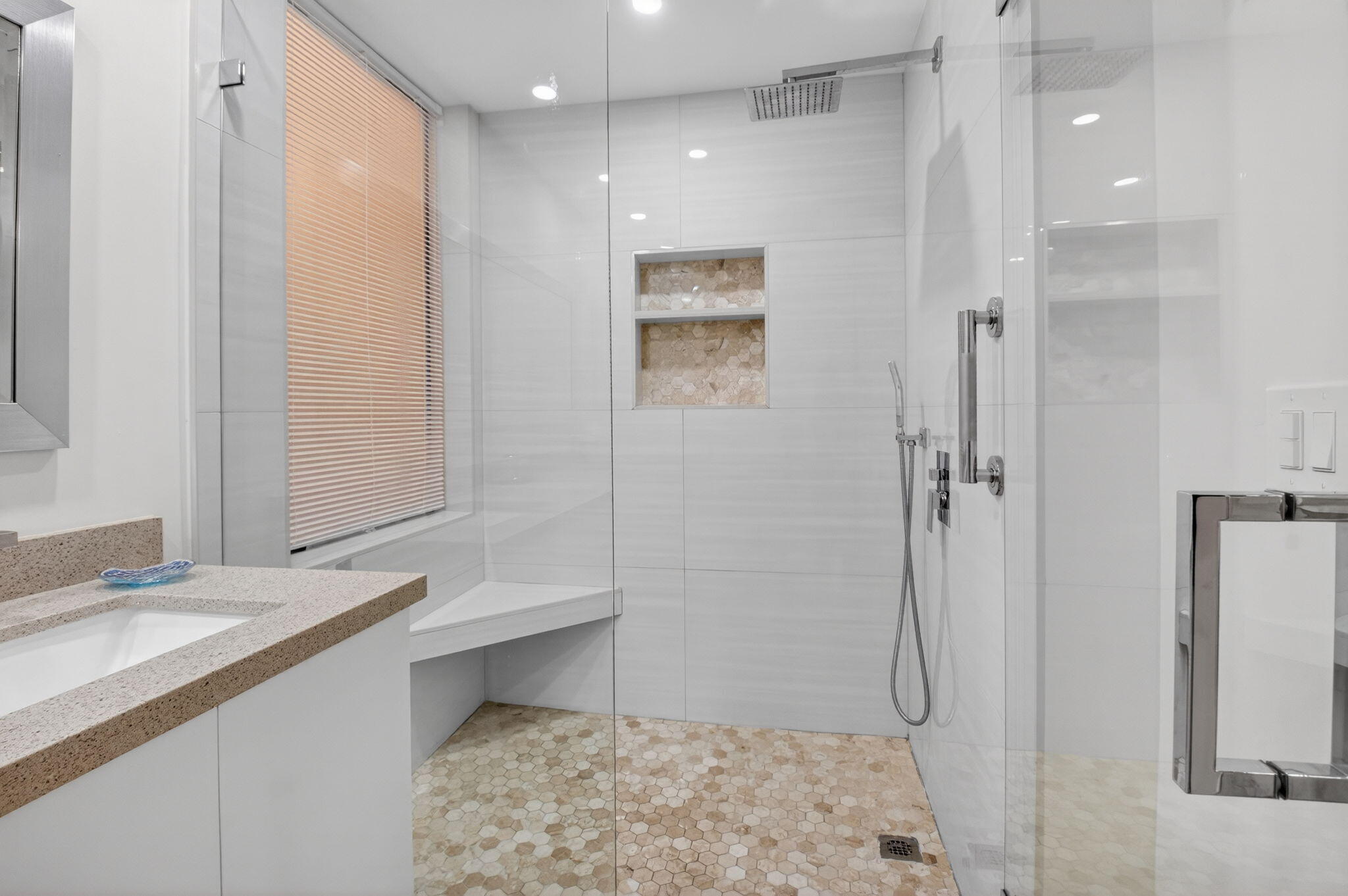 7484 La Paz Boulevard, Unit 103 Boca Raton, FL 33433 - Photo 28 of 50 a bathroom with a granite countertop sink a toilet and shower