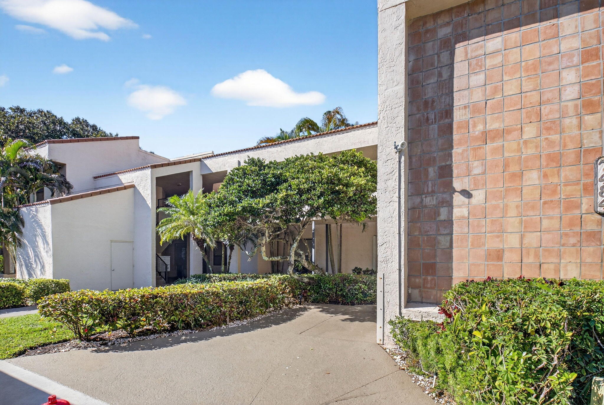 7484 La Paz Boulevard, Unit 103 Boca Raton, FL 33433 - Photo 34 of 50 a front view of a house with a yard