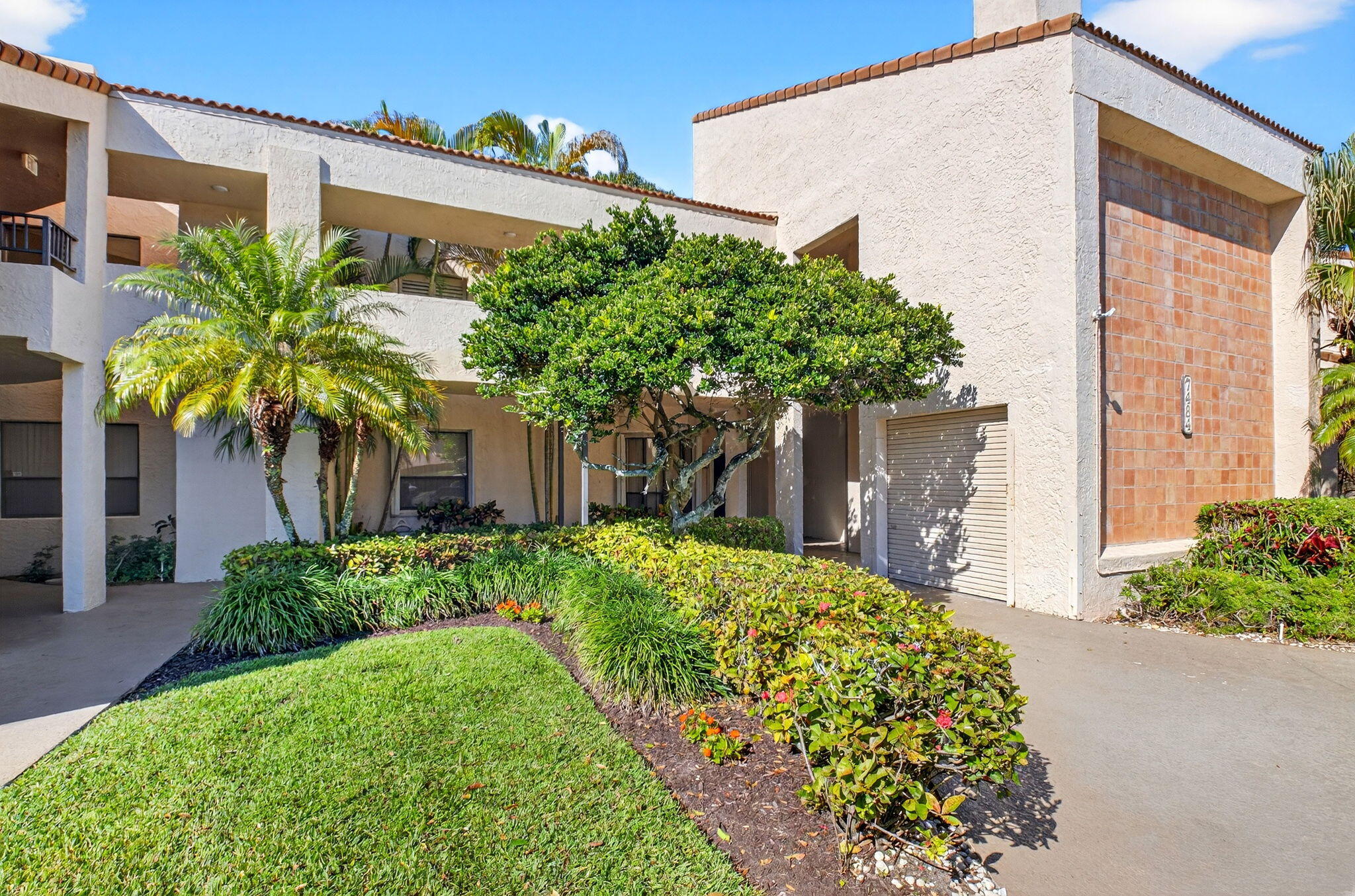 7484 La Paz Boulevard, Unit 103 Boca Raton, FL 33433 - Photo 35 of 50 a front view of a house with a yard