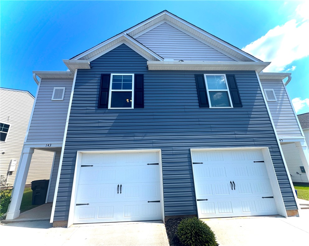 143 Adger Road Pendleton, SC 29670 - Photo 4 of 30 Clean lines and classic siding define this contemporary multi-level facade with integrated two-car garage bays.