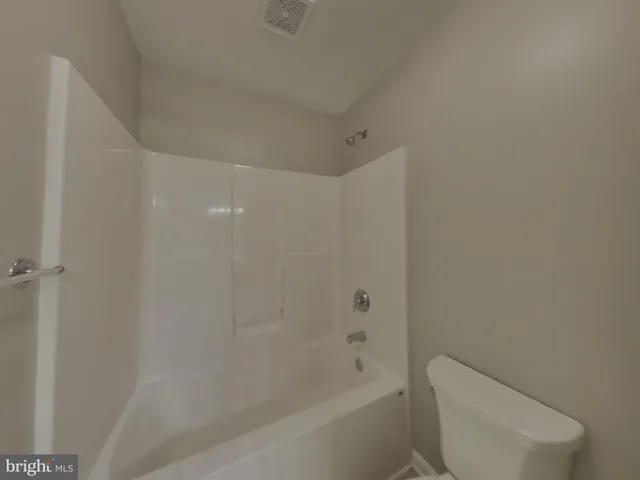 a bathroom with a bathtub and toilet
