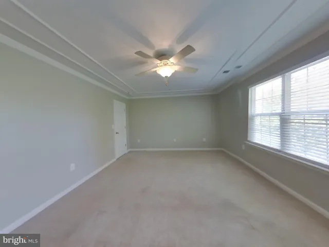 a view of room with a ceiling fan and window