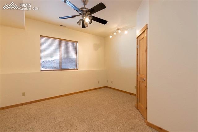 17873 Sawmill Road Colorado Springs, CO 80908 - Photo 29 of 36 Basement bedroom with garden level window and walk-in closet