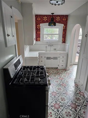 a kitchen with a stove and a refrigerator