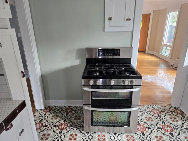 a kitchen with wooden cabinets and a stove top oven