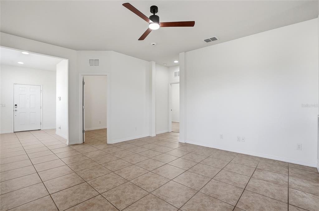 1724 Passage Key Lane Ruskin, FL 33570 - Photo 11 of 46 an empty room with projector and fan