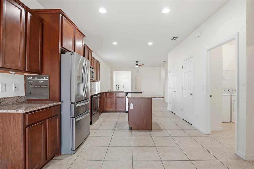 1724 Passage Key Lane Ruskin, FL 33570 - Photo 16 of 46 a kitchen with stainless steel appliances granite countertop a refrigerator and a sink