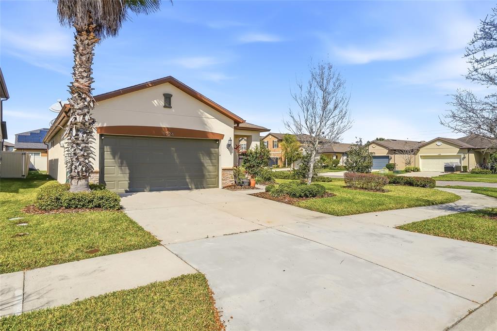 1724 Passage Key Lane Ruskin, FL 33570 - Photo 2 of 46 a front view of a house with a yard and garage