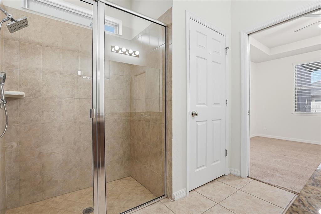1724 Passage Key Lane Ruskin, FL 33570 - Photo 30 of 46 a bathroom with a glass shower door