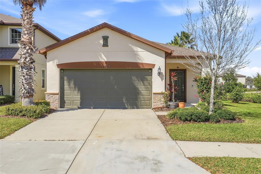 1724 Passage Key Lane Ruskin, FL 33570 - Photo 3 of 46 a front view of a house with a yard and trees