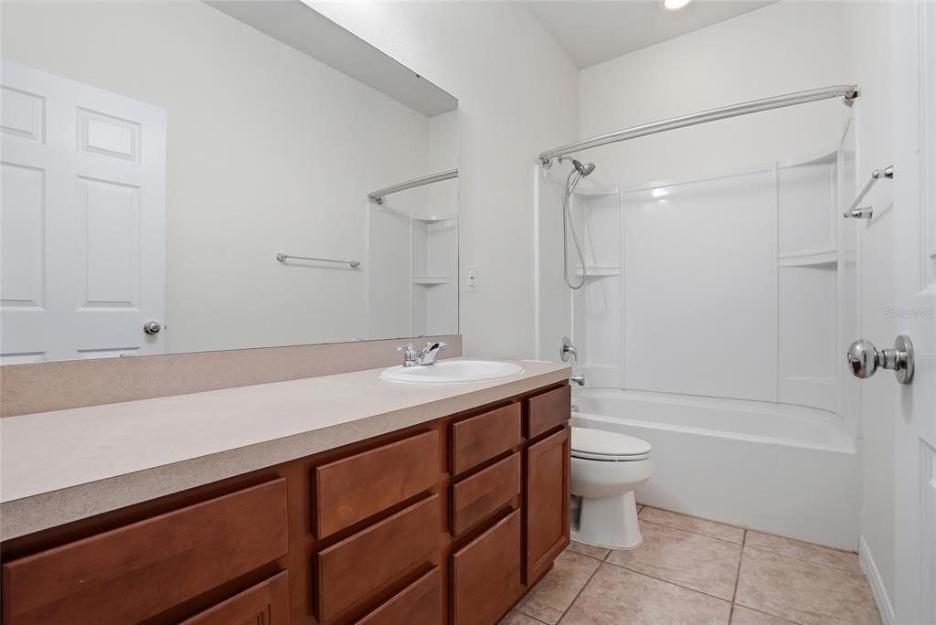 1724 Passage Key Lane Ruskin, FL 33570 - Photo 32 of 46 a bathroom with a sink a toilet and shower