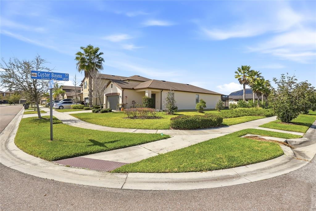 1724 Passage Key Lane Ruskin, FL 33570 - Photo 4 of 46 a view of a white house with a swimming pool and yard