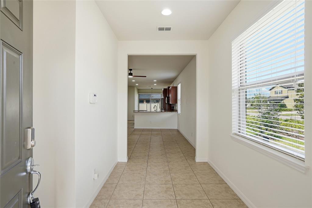 1724 Passage Key Lane Ruskin, FL 33570 - Photo 6 of 46 a view of a hallway with a window and a bathroom