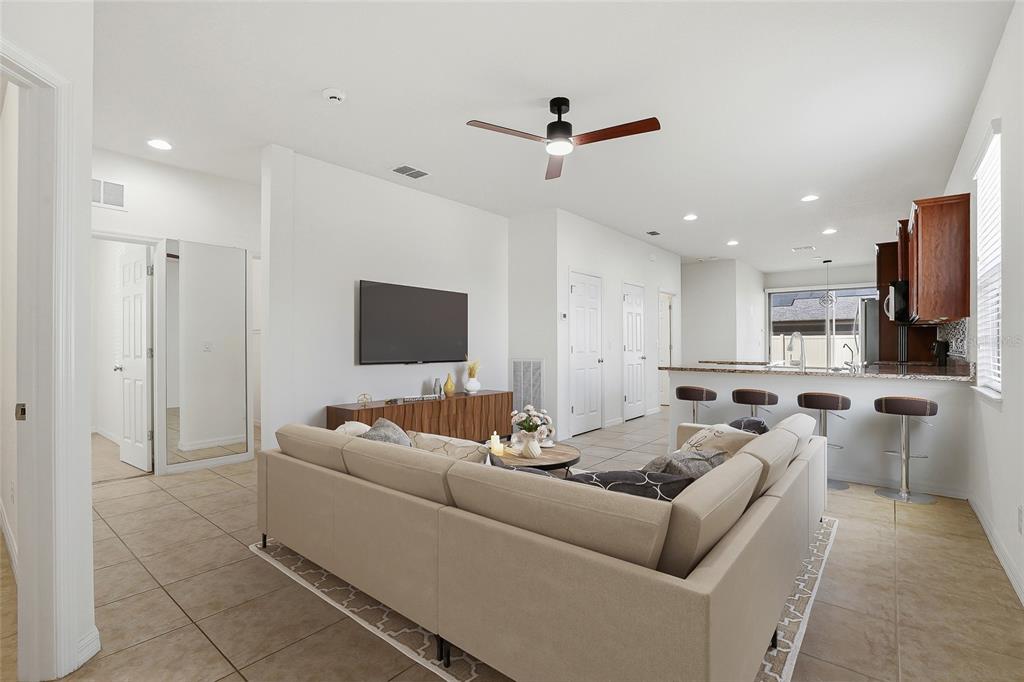 1724 Passage Key Lane Ruskin, FL 33570 - Photo 7 of 46 a living room with furniture and a flat screen tv