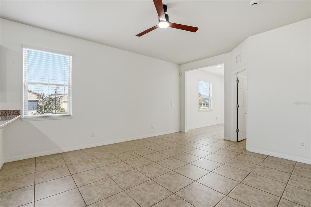 1724 Passage Key Lane Ruskin, FL 33570 - Photo 10 of 46 a view of an empty room with window and chandelier fan
