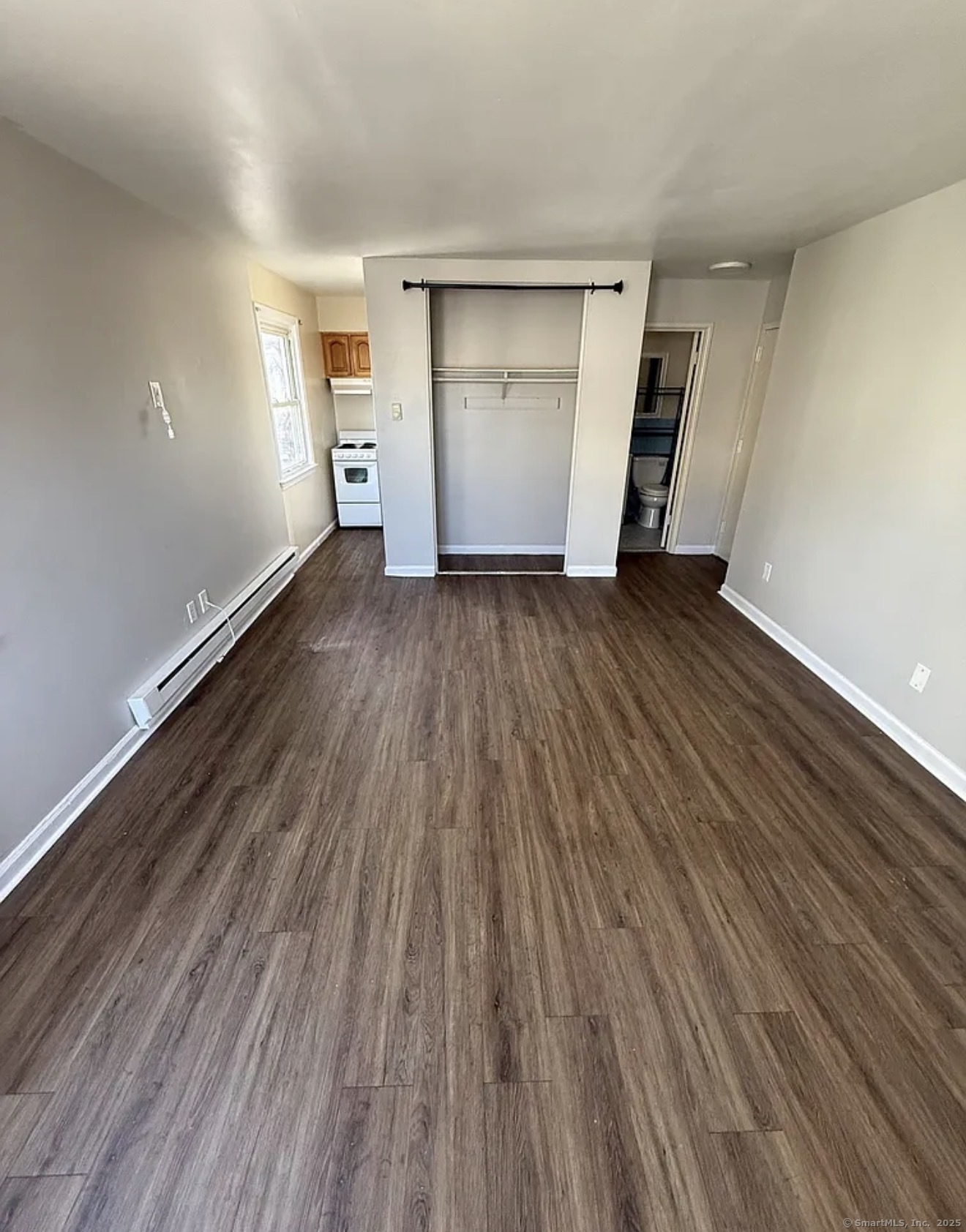52 McKinley Avenue, Unit 9 Bridgeport, CT 06606 - Photo 2 of 3 a view of empty room with wooden floor
