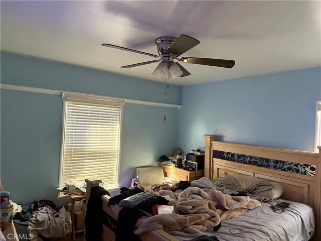 a bedroom with bed and a window