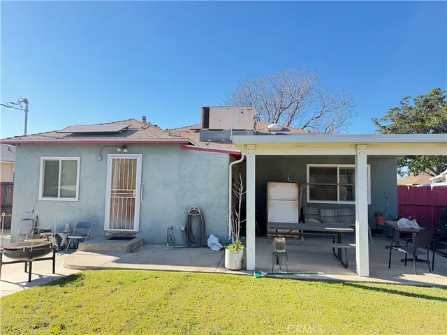 a view of a house with swimming pool and furniture