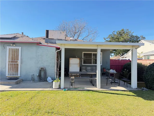 a view of a house with pool and chairs