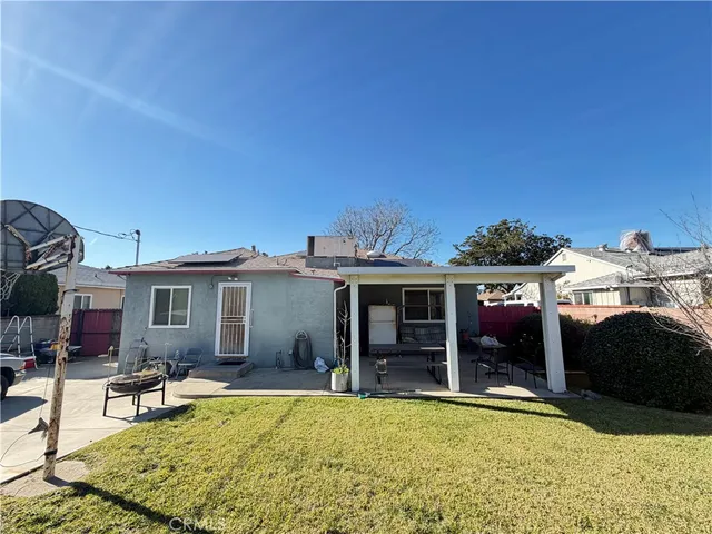 a view of a house with swimming pool and sitting area
