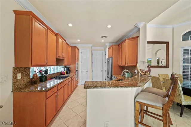 a kitchen with stainless steel appliances granite countertop sink stove and cabinets