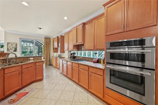 a kitchen with stainless steel appliances a stove sink and cabinets