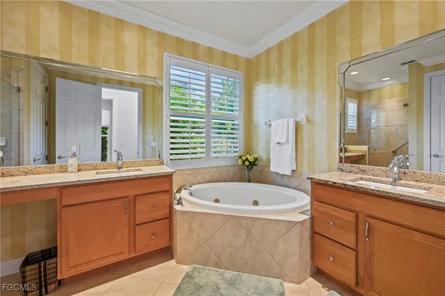 a bathroom with a tub sink and mirror