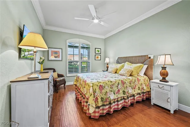 a bedroom with a bed and a flat tv screen on dresser