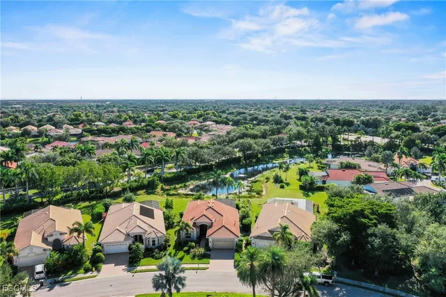 an aerial view of house with yard swimming pool and ocean view